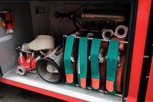 Detailed view of firefighting equipment in action during training exercises at a fire station in an urban area at midday. photo