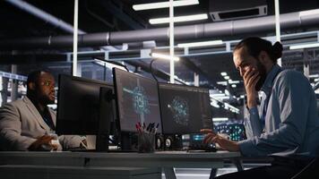 Server room IT specialist frustrated by difficult complex tasks in office. Stressed engineer developing neural network software while working extended hours in data center, camera A video