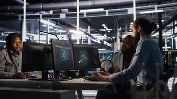 Lead data center engineer oversees team integrating AI automation tools during infrastructure maintenance. Worker under manager supervision uses machine learning models for operational tasks, camera A video