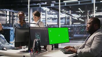 Data center admin using isolated screen PC to monitor neural network AI. Server room employee using mockup computer to oversee rigs powering machine learning processes, camera A video