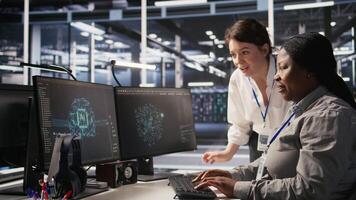 Cheerful data center technicians satisfied with results after collaborating on AI automation deployment. Happy server hub coworkers adjust machine learning configurations, working together, camera A video