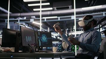 Data center employee wearing VR headset using artificial intelligence neural networks technology. Server farm programmer using AI programming language and virtual reality to update hardware, camera A video
