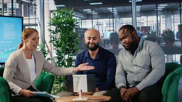 Group of professionals using remote communication tools for business meeting, focusing on strategy planning and investment discussions. Diverse organizational environment. Camera B. video