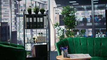 Interior of corporate workspace showing conference room prepared for a meeting with stationery, decorations and table arrangement reflecting organized business environment and readiness. video