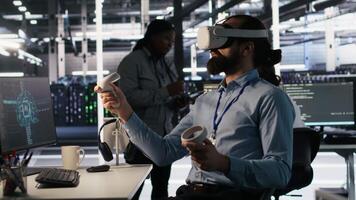 Admin using VR headset in data center to update server tech, configuring equipment using software tools. Server farm employee reviewing hardware analytics using virtual reality, camera A video