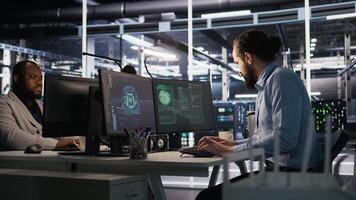 Employee requesting help from manager to fix hacked equipment systems. Stressed data center admin reacting to spyware popup on computer screen, launching emergency response protocol, camera A video
