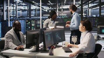 Data center engineers performing maintenance on blade server units used for artificial intelligence processing. IT professionals manage data center arrays used for machine learning training, camera A video