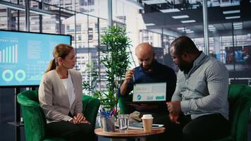 Executive business group in formal office focused on strategic planning, decision making and performance analysis for growth. Supporting leadership goals across multicultural workforce. Camera A. video