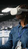 Vertical Data center admin wearing VR headset using artificial intelligence neural networks technology. Server hub developer using AI programming language and virtual reality to update hardware, camera B video