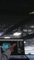 Vertical Military personnel overseeing AI computing operations on laptop in high tech server facility. Army tech experts using artificial intelligence to oversee communication systems, camera B video