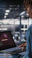 Vertical Data center programmer panicking after receiving critical error popup on laptop display. Server farm worker alerted by bugs causing low hardware performance while troubleshooting systems, camera A video