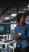 Vertical Engineers working together on data center industrial platform, completing software updates. Server hub colleagues doing brainstorming, finetuning server rig configurations, camera B video
