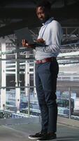 Vertical System administrators in data center using laptop to monitor neural network LLM visualization. Server hub teamworking colleagues overseeing rigs powering machine learning processes, camera A video