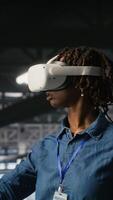Vertical Engineer on data center industrial platform analyzing performance outputs using virtual reality tech. Server hub colleagues finetuning server rig configurations using VR headset tech, camera B video