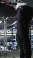 Vertical Annoyed engineer in data center reacting to critical error message on laptop. Irked IT professional attempts to resolve system fault impacting backend infrastructure performance, camera A video