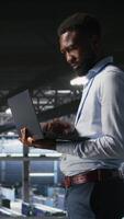 Vertical IT experts on data center industrial platform pleased by neural network outputs after completing AI software updates. Cheerful system administrators finetuning server rig configurations, camera A video