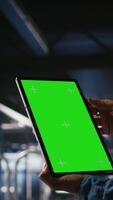 Vertical Close up of server hub admin using isolated screen tablet next to colleague reviewing AI LLM visualization. Data center employee using mockup device to monitor machine learning systems, camera A video