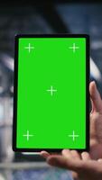 Vertical Military technicians in data center use green screen mockup tablet to monitor systems. Army operators in server room ensuring stable infrastructure using chroma key device, camera B video