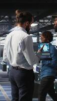 Vertical Army technicians in command center server room using artificial intelligence to detect cyber threats. Military data center experts use AI detection software to secure defense systems, camera A video