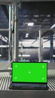Vertical Isolated screen laptop automating supercomputers hardware inside server hub. Chroma key notebook in industrial data center facility monitoring rackmounts neural network activity video