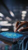 Vertical Close up of data center engineer using tablet, doing maintenance on rigs handling AI processing tasks. Server hub computer scientist managing storage arrays supporting deep learning tech, camera A video