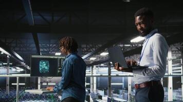 Smiling data center engineering team on industrial platform collaborating on neural network software tasks. Jolly server hub colleagues working together, visualizing large language model architecture video