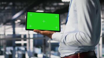 Close up of server farm developer using isolated screen tablet, reviewing AI LLM visualization. Data center IT specialist using mockup device to monitor deep learning systems, camera B video