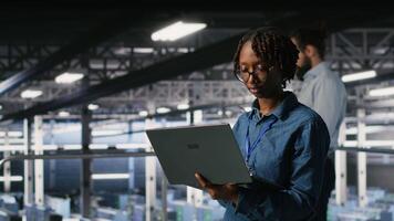 Data center software developers using devices to review AI LLM visualizations. IT professionals working together to analyze neural networks outputs, ensuring stable gear operations video