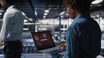 Data center programmer panicking after receiving critical error popup on laptop display. Server farm worker alerted by bugs causing low hardware performance while troubleshooting systems, camera A video