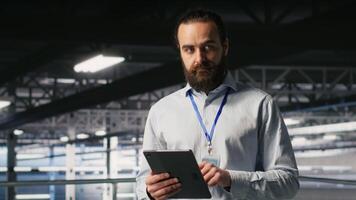 Portrait of smiling engineer in data center monitoring neural network LLM visualization. Cheerful server hub IT specialists overseeing rigs powering machine learning processes, camera B video