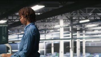 System administrators in data center using laptop to monitor neural network LLM visualization. Server hub teamworking colleagues overseeing rigs powering machine learning processes, camera B video