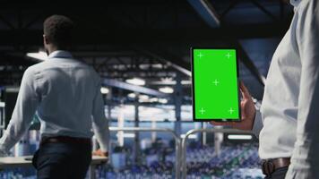 Close up of data center admin using mockup tablet to update storage arrays software, configuring network virtualization. Server room IT expert using chroma key device to verify settings, camera A video
