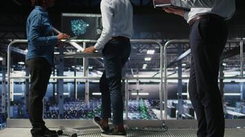 Annoyed engineer in data center reacting to critical error message on laptop. Irked IT professional attempts to resolve system fault impacting backend infrastructure performance, camera A video