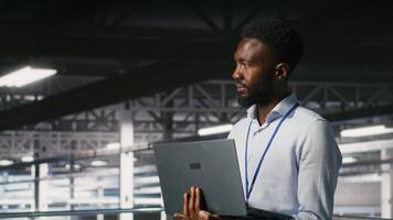 Engineers in data center using laptop to monitor neural network LLM visualization. Coworkers on server hub industrial platform overseeing server clusters powering machine learning processes, camera B video