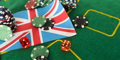 Gambling Poker chip on British Union Jack flag close up selective focus photo