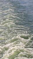 Close-up of water waves and foam, Detailed view of rippling water and foam created by a boat's wake video