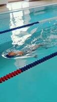 Swimmer splashing in pool lane, Swimmer creating splashes while practicing in a pool lane video