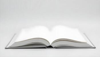A close-up shot of an open book, showing blank pages with a white background. photo