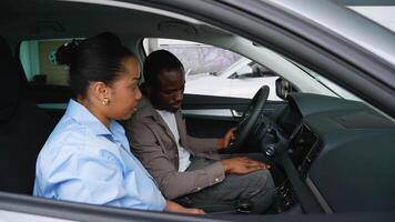Couple testing new car features with saleswoman assistance video