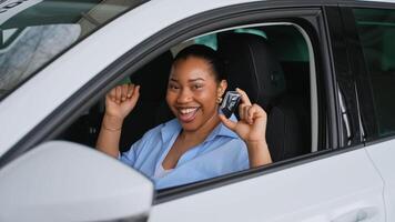 Happy customer showing new car key while sitting inside video