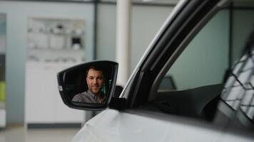 Happy customer showing car key while sitting in new car video