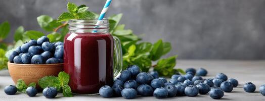 Blueberry smoothie with blueberries and mint leaves on a gray background photo