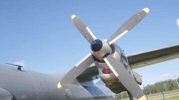 Close view of a vintage aircraft propeller rotating on a sunny afternoon at an airfield, showcasing its design and engineering in excellent condition. video