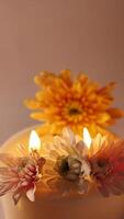 Celebrations of Diwali or Deepavali holiday in India with candles and flowers in the evening at night close-up. Hindus celebrate the festival of lights, vertical video