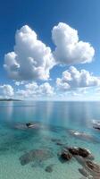A beautiful beach with blue water and clouds photo