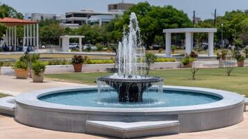 A fountain in a park with a fountain in the middle photo