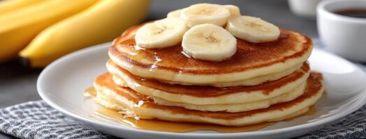 A stack of pancakes with bananas on top photo