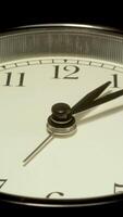 A close up of a clock time lapse with black background. video