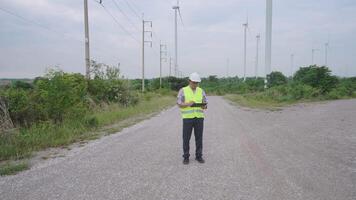 Super wide shot and moving camera of engineer working at wind turbine field generating electricity video