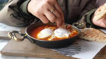 Enjoying a delicious breakfast dish with poached eggs video